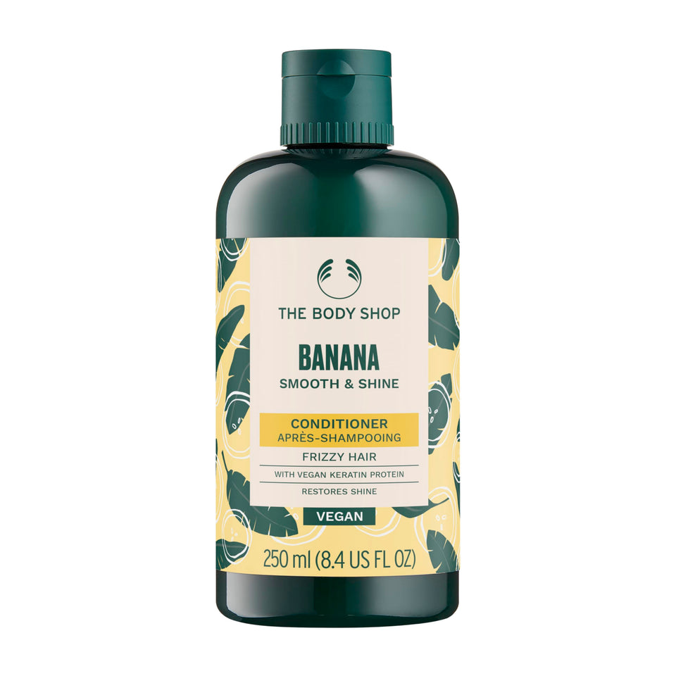 The Body Shop Banana Conditioner bottle close-up highlighting nourishing formula for dry, frizz-prone hair
