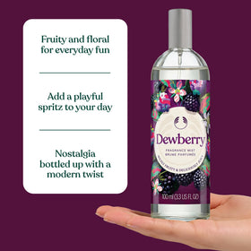 The Body Shop Dewberry Fragrance Mist being applied to clothes for subtle scent layering.