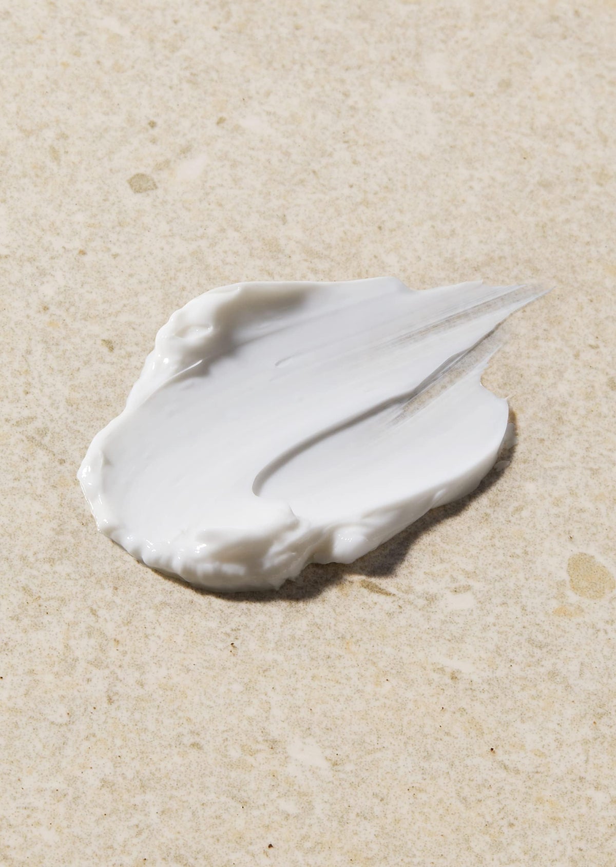 The Body Shop Vitamin E Night Cream on a bedside table hints at overnight hydration.