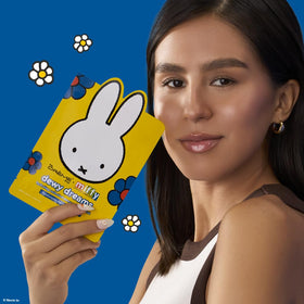 Applying The Crème Shop Miffy Dewy Dreams mask shows an easy at-home skincare moment.