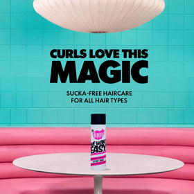 The Doux WE WANT EASY Texture Tamer applied to damp curls for detangling