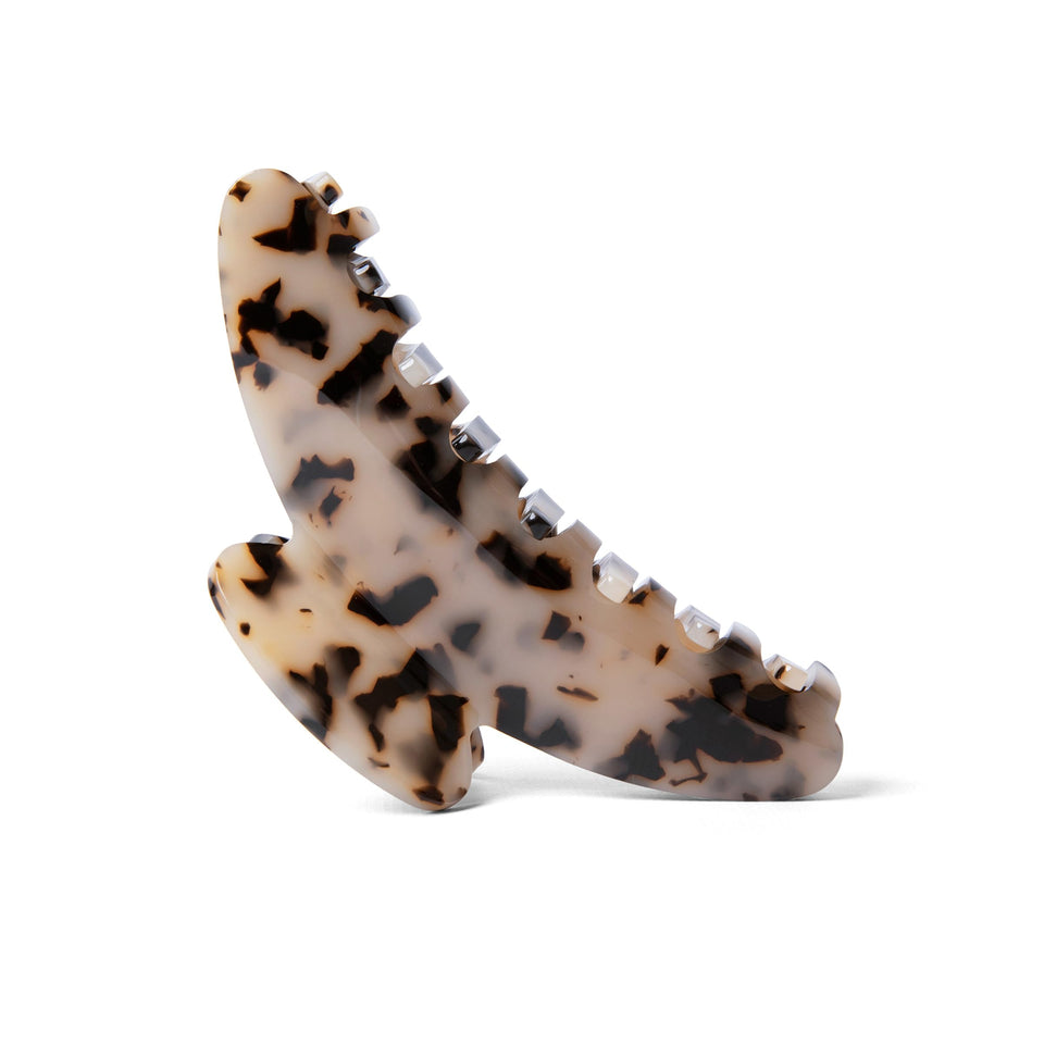 The Hair Edit Vogue tortoise claw clip in side view, securing updos with a neutral print.