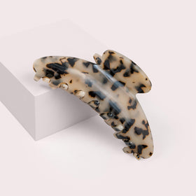 The Hair Edit Vogue tortoise claw clip worn in hair for a chic half-up style.