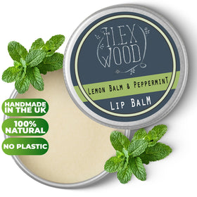 A hand holds The Ilex Wood lip balm for on-the-go use