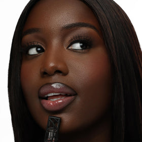 The Lip Bar Upscale Warm Mauve lip gloss swatches on arm show buildable color
