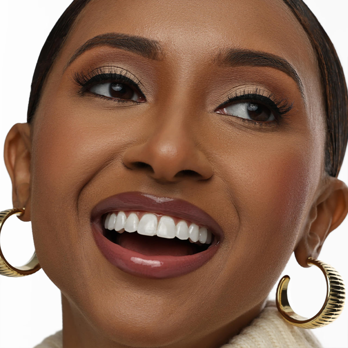 The Lip Bar Upscale Warm Mauve gloss texture close-up reveals a silky, non-sticky shine