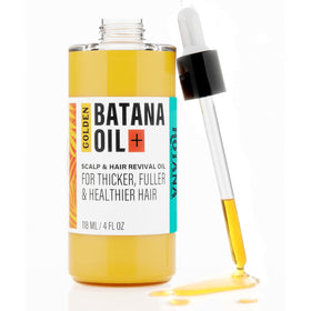 The-Mix-Up Golden Batana Oil bottle pours to nourish hair and scalp.