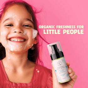 A child applying The Natural and Organic Family foaming face wash to the face during daily routine.