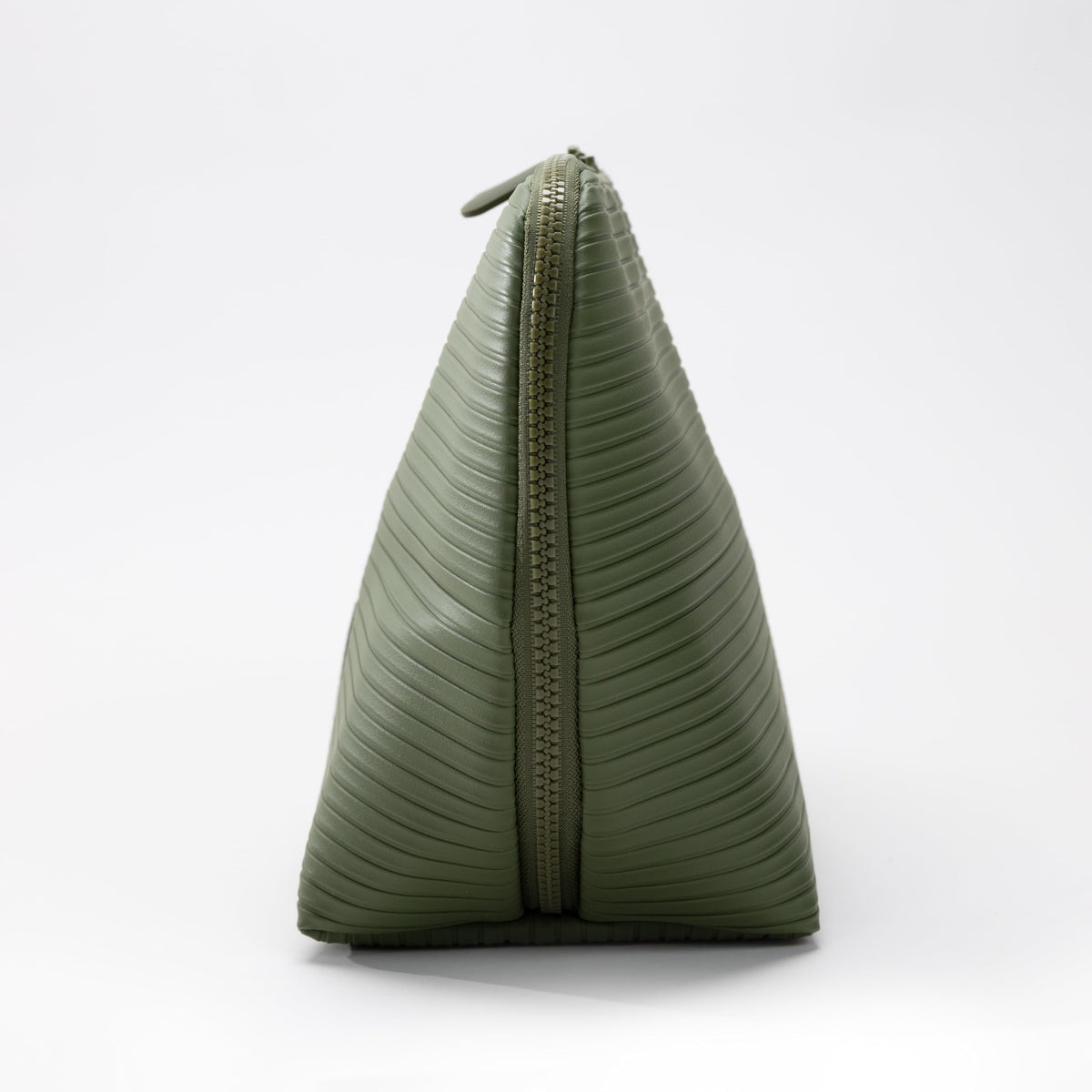 THE VERTI olive medium vertical bag on vanity showing compact organization in action
