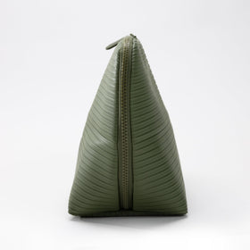 THE VERTI olive medium vertical bag on vanity showing compact organization in action