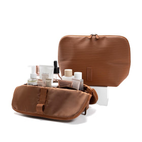 The Verti vertical waterproof bag front view showing organized pockets for skincare and toiletries.