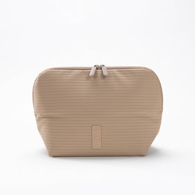 The Verti waterproof fabric in sandstone protects contents during travel and spills