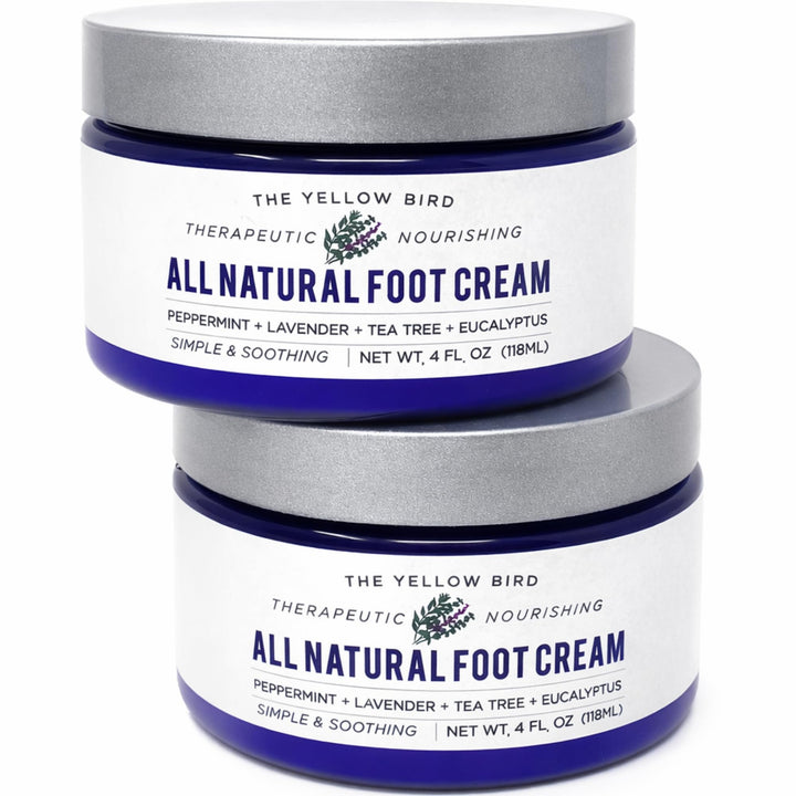 The Yellow Bird Foot Cream bottle close-up showing organic ingredients for deep hydration.