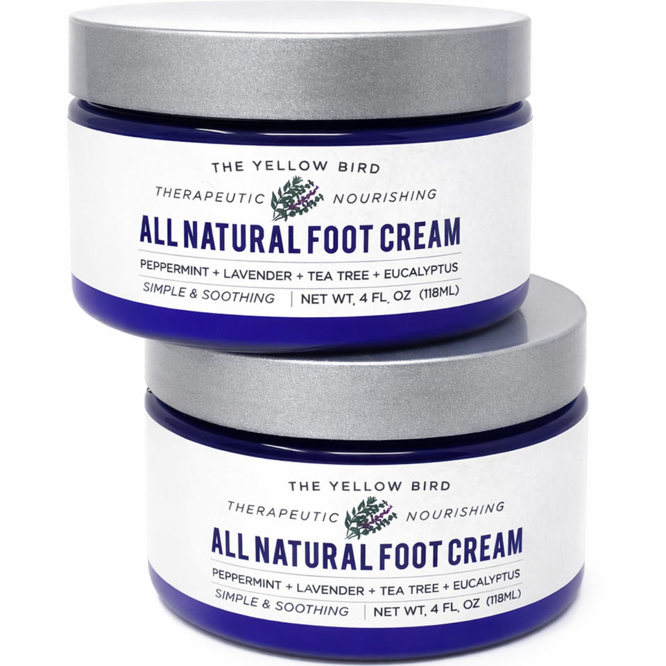 The Yellow Bird Foot Cream bottle close-up showing organic ingredients for deep hydration.