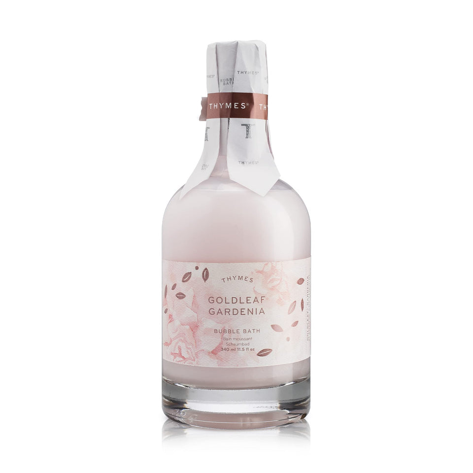 Thymes Bubble Bath Goldleaf Gardenia bottle on a bathroom shelf ready to start a relaxing soak