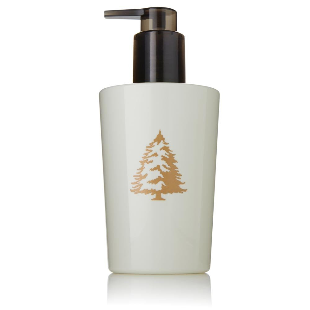 Thymes Frasier Fir hand lotion bottle provides hydration with a crisp, seasonal scent.