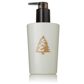 Thymes Frasier Fir hand lotion bottle provides hydration with a crisp, seasonal scent.