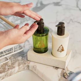 Thymes Frasier Fir hand wash decor in a bathroom enhances seasonal ambiance.