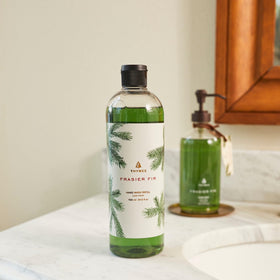 Thymes Frasier Fir refill pump beside sink for quick, mess-free dispensing.