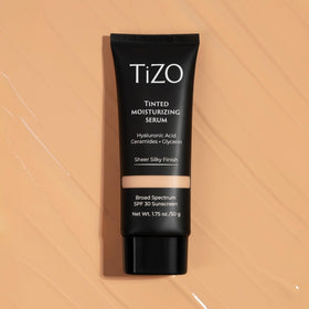 Applying TIZO tinted serum on hand demonstrates easy blend for a sheer finish
