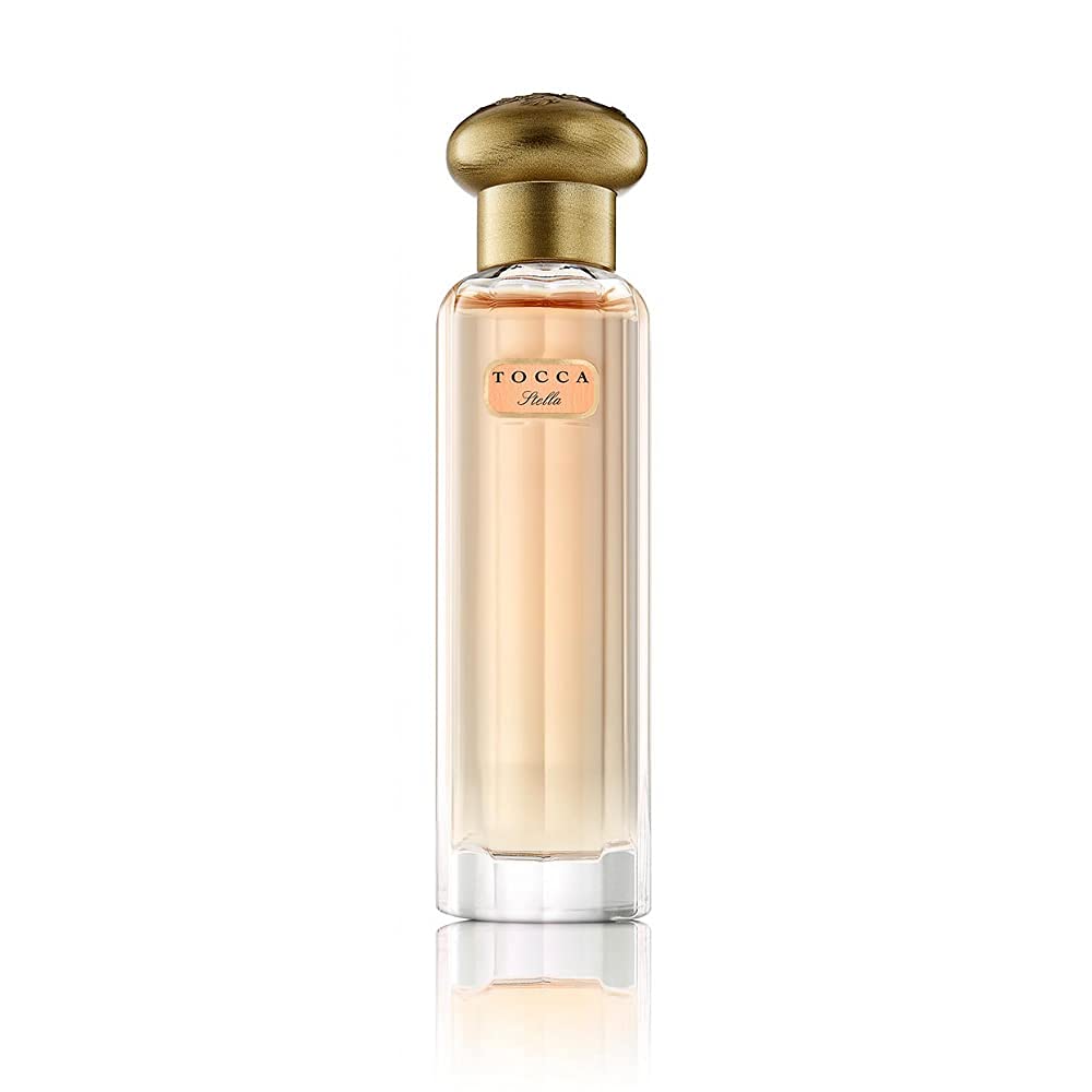 TOCCA Stella bottle close-up highlights vibrant blood orange and freesia notes