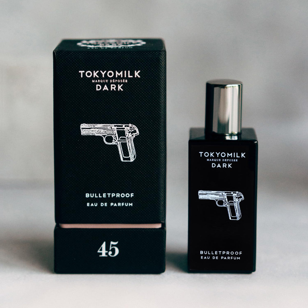 TOKYOMILK Dark Bulletproof bottle side profile with elegant black packaging.