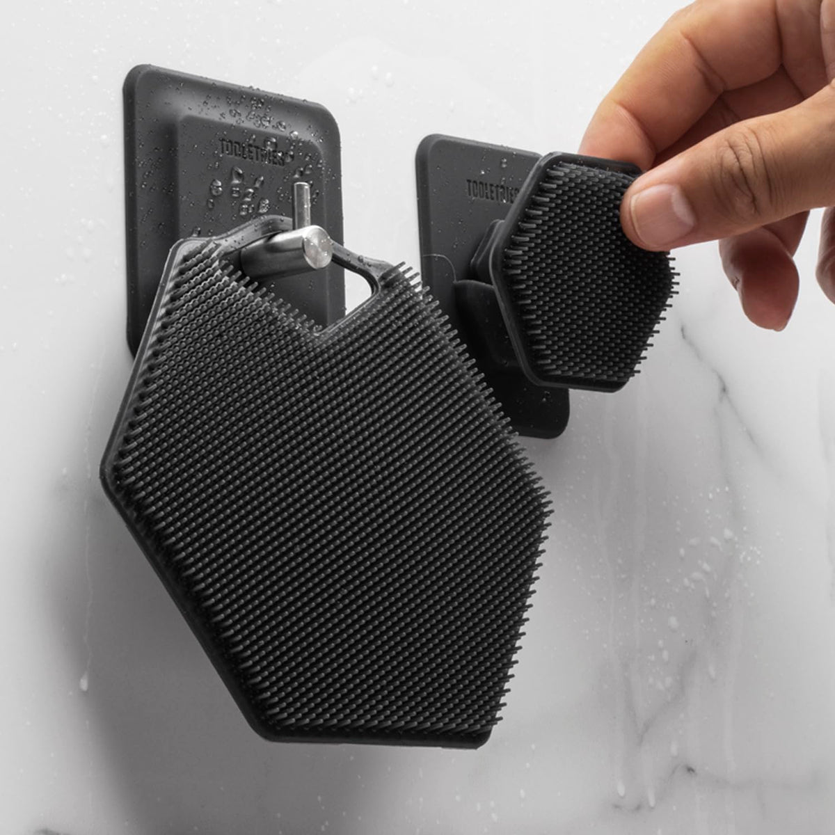 TOOLETRIES Arnold holder showing secure silicone grip on a mirror.