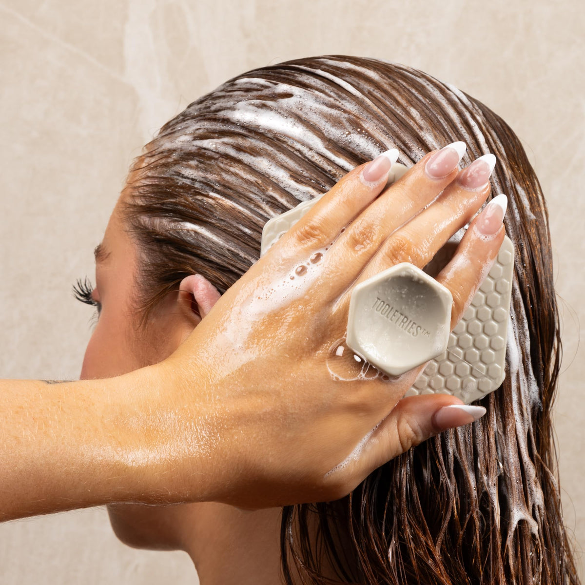 TOOLETRIES scalp scrubber ergonomic handle for easy grip during shower.