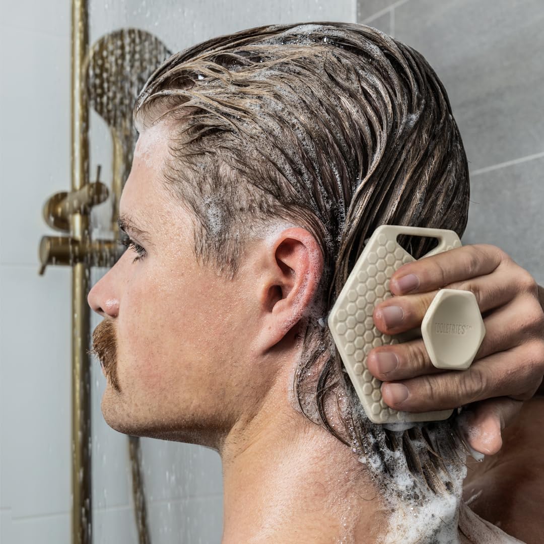 TOOLETRIES scalp scrubber travel-size design for on-the-go grooming.