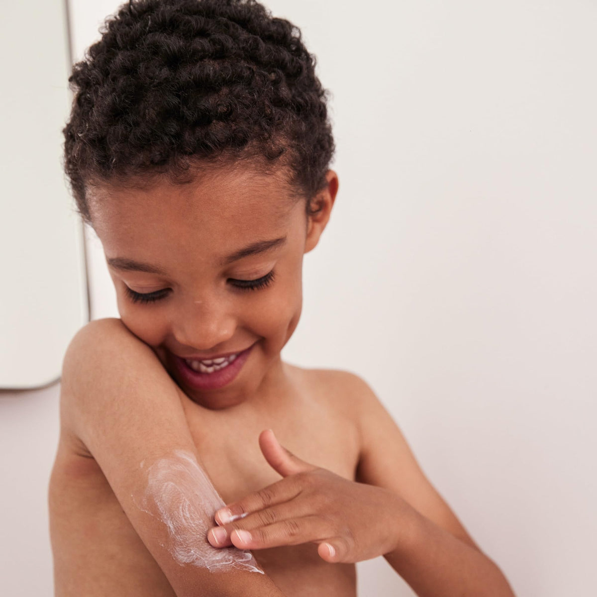 Topicrem Atopic Skin AD Emollient Balm application, smooth cream glides on irritated areas with comfort.