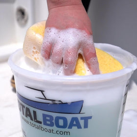 TotalBoat marine cleaner foaming action on deck for streak-free washing.