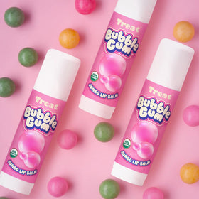 Application on lips demonstrates easy, kissable shine from Treat Jumbo Bubble Gum Lip Balm.