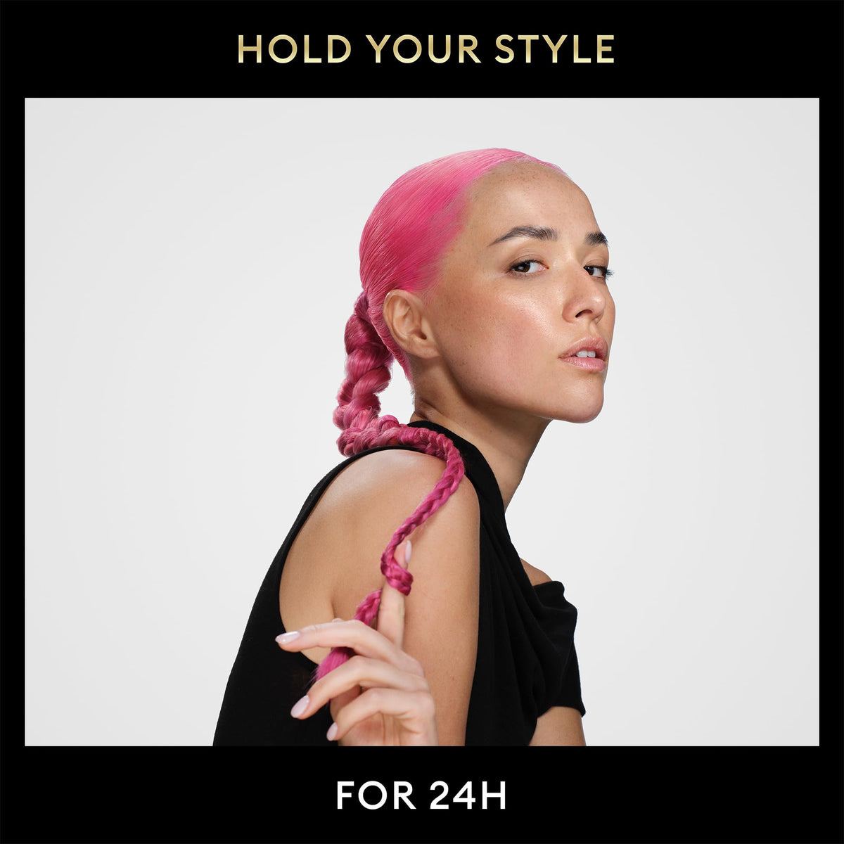 Spraying on hair with TRESemmé to demonstrate frizz control and smooth finish.