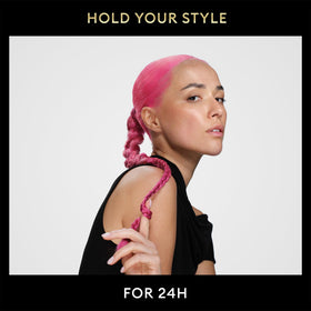 Spraying on hair with TRESemmé to demonstrate frizz control and smooth finish.