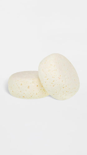 Trish McEvoy Sexy 9 body sponge with soft foaming texture for gentle exfoliation.