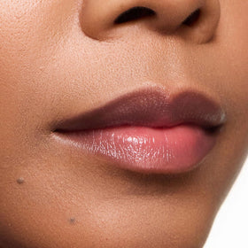 Close-up texture of Mulberry lip color, moisturizing feel on lips.