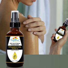 Tropical Holistic Vitamin E Oil on face and neck for hydration.