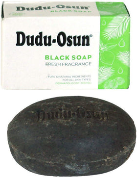 Tropical Naturals Dudu Osun African Black Soap Original bar in hand supports soothing skincare routines.