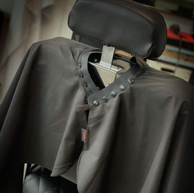 TRU BARBER cape with snap closure demonstrates secure fitting