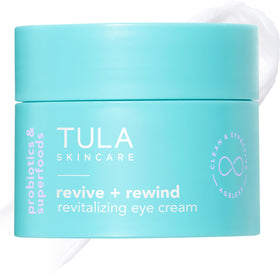 TULA Revive & Rewind Eye Cream tube close-up smoothing the delicate eye area with hydration.