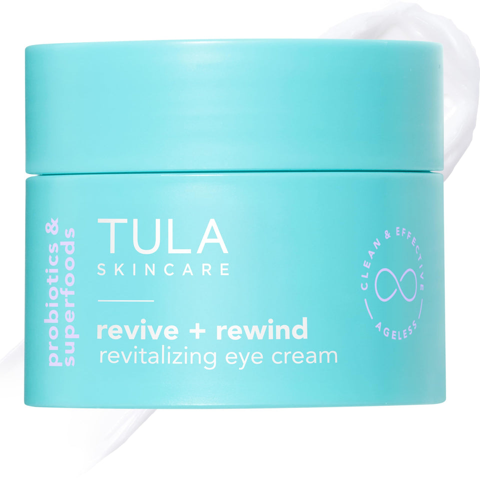 TULA Revive & Rewind Eye Cream tube close-up smoothing the delicate eye area with hydration.