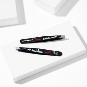 Tweezerman brow tweezer in use for precise shaping.