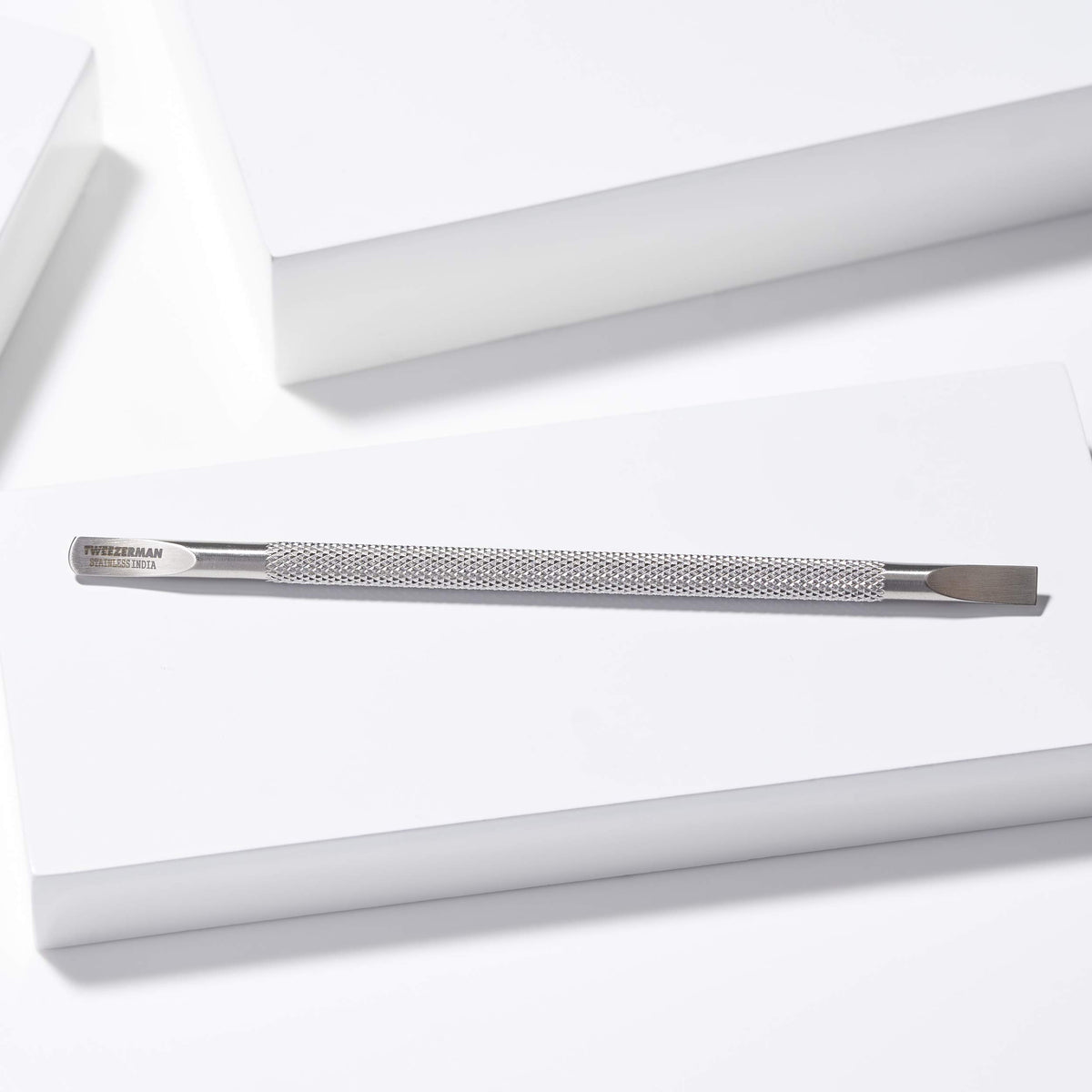 Tweezerman Cuticle Pushy curved edge cleans around and under nails.