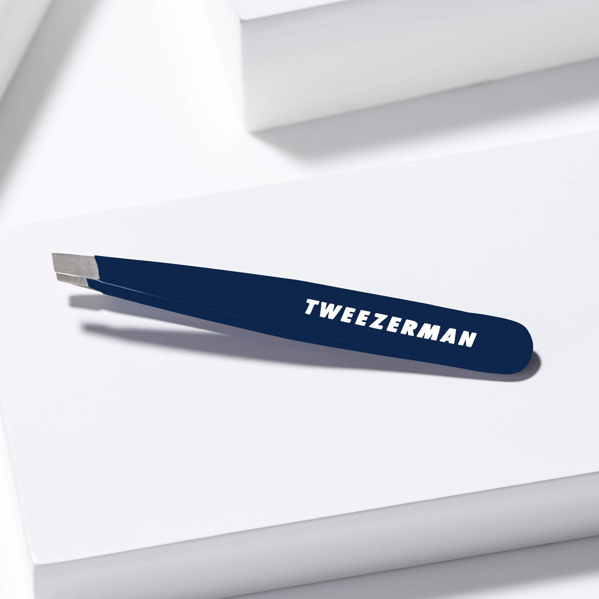 Tweezerman Evening Blue Mini Slant Tweezer close up of hand filed tips.