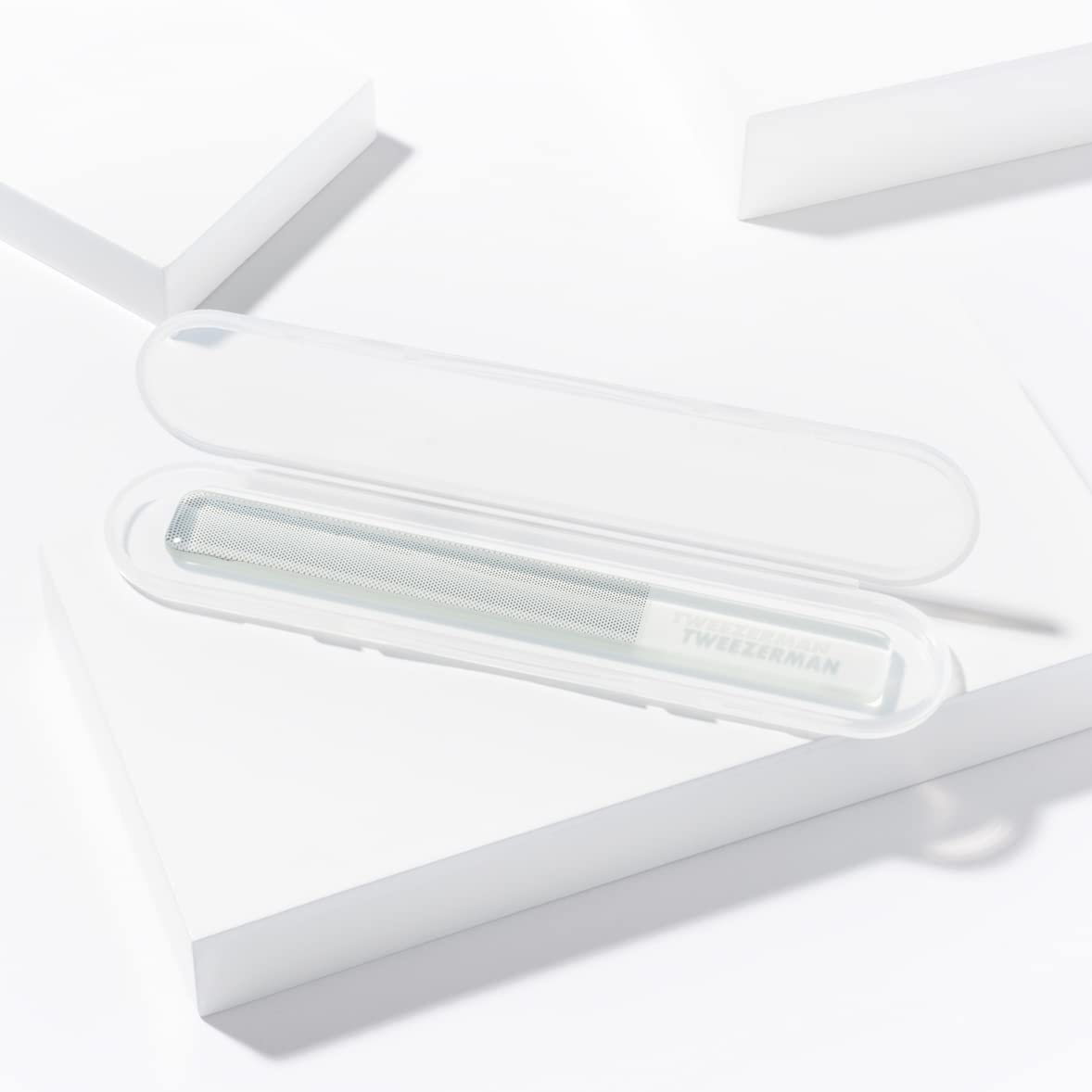Tweezerman Glass Nail Buffer polishing nails with a high shine finish.