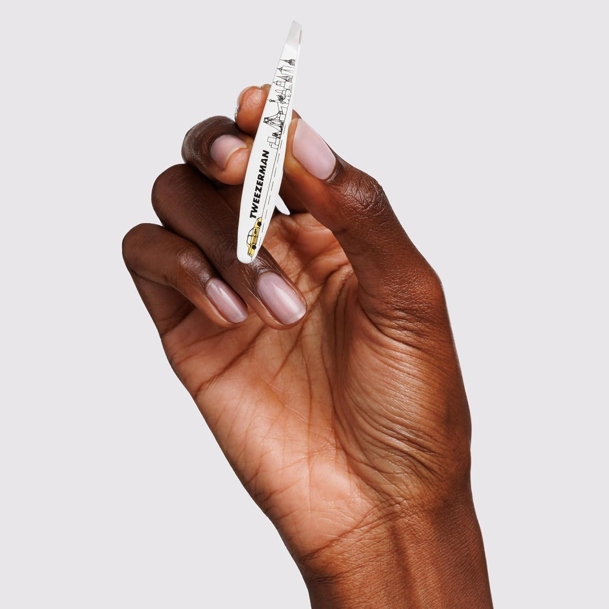 Tweezerman NYC Mini Slant Tweezer, perfect for precise brow shaping and hair removal.