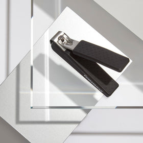 Tweezerman precision grip blades close-up show curved edges for natural nail shaping.