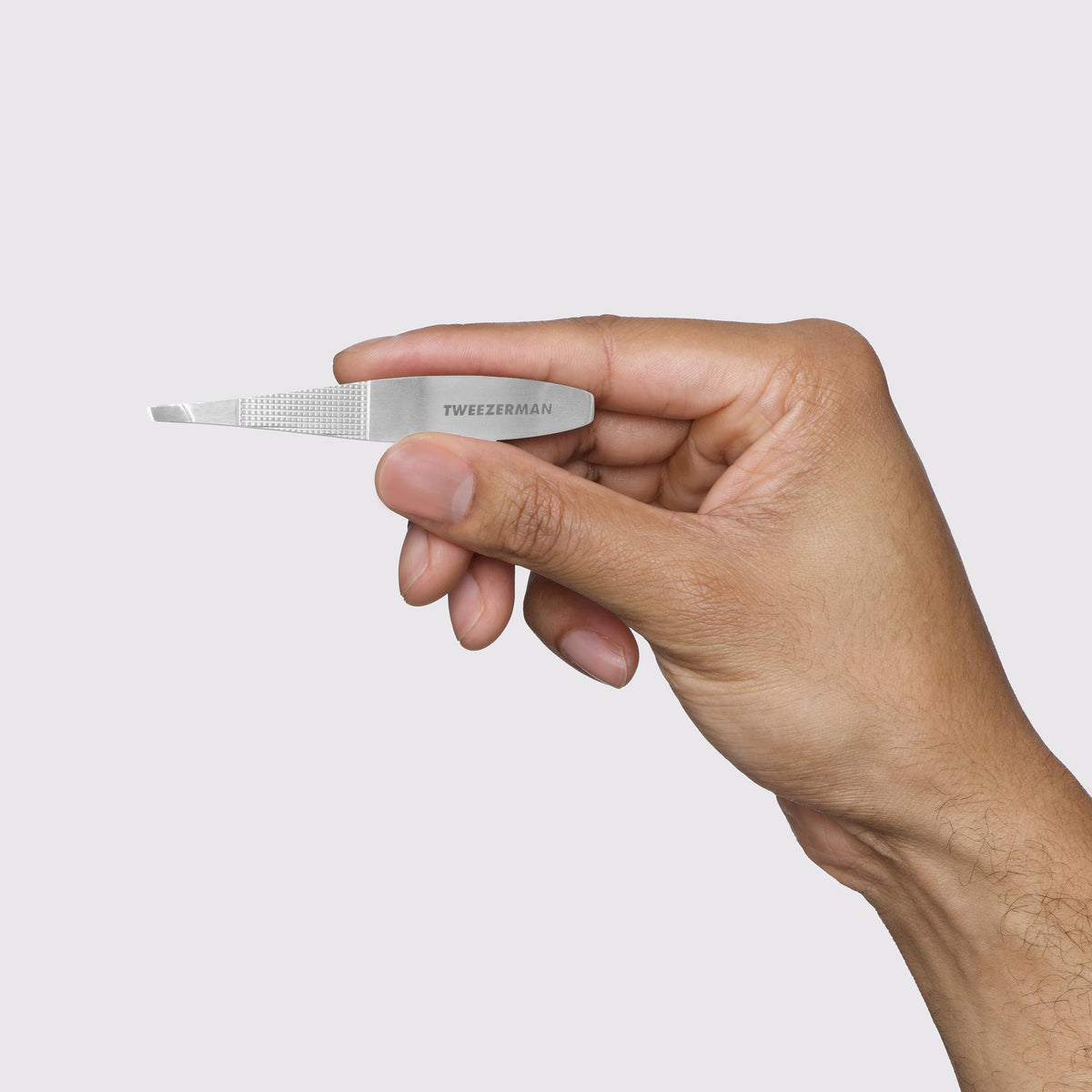 Hand-filed tips on Tweezerman Slant Tweezer grab hair cleanly from the root.