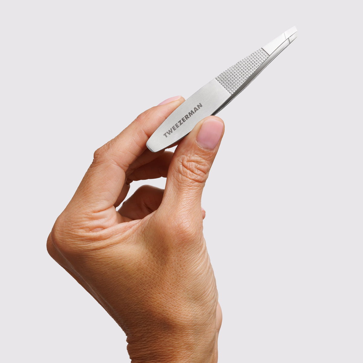 Close-up of Tweezerman Wide Grip Slant Tweezer showing its widened body for comfort.