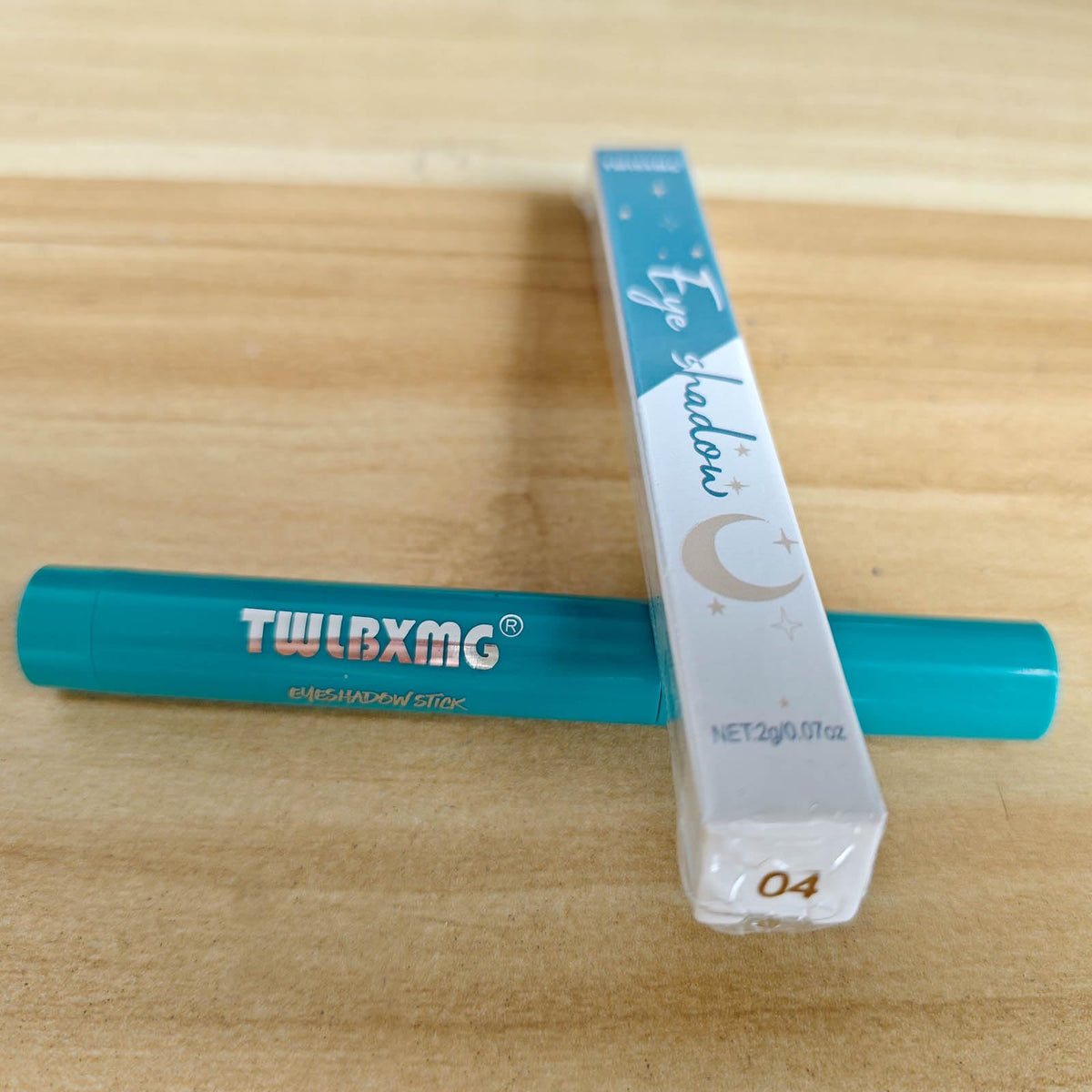 TWLBXMG nude glitter eyeshadow stick displays natural shimmering shade.